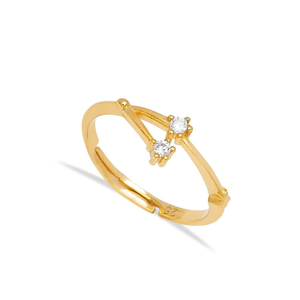 Delicate gold-toned ring with two sparkling diamond-like stones, showcased in a simple yet elegant design from Twin Jewellery.