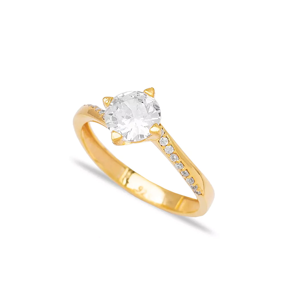 Elegant gold solitaire engagement ring with sparkling cubic zirconia stone and shimmering crystal-encrusted band, perfect for a glamorous evening or special event.