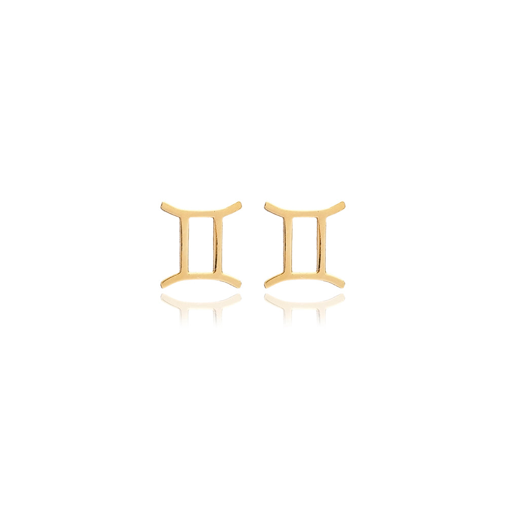 Minimalist gold-toned earrings in the shape of the Gemini astrological sign displayed against a plain background.
