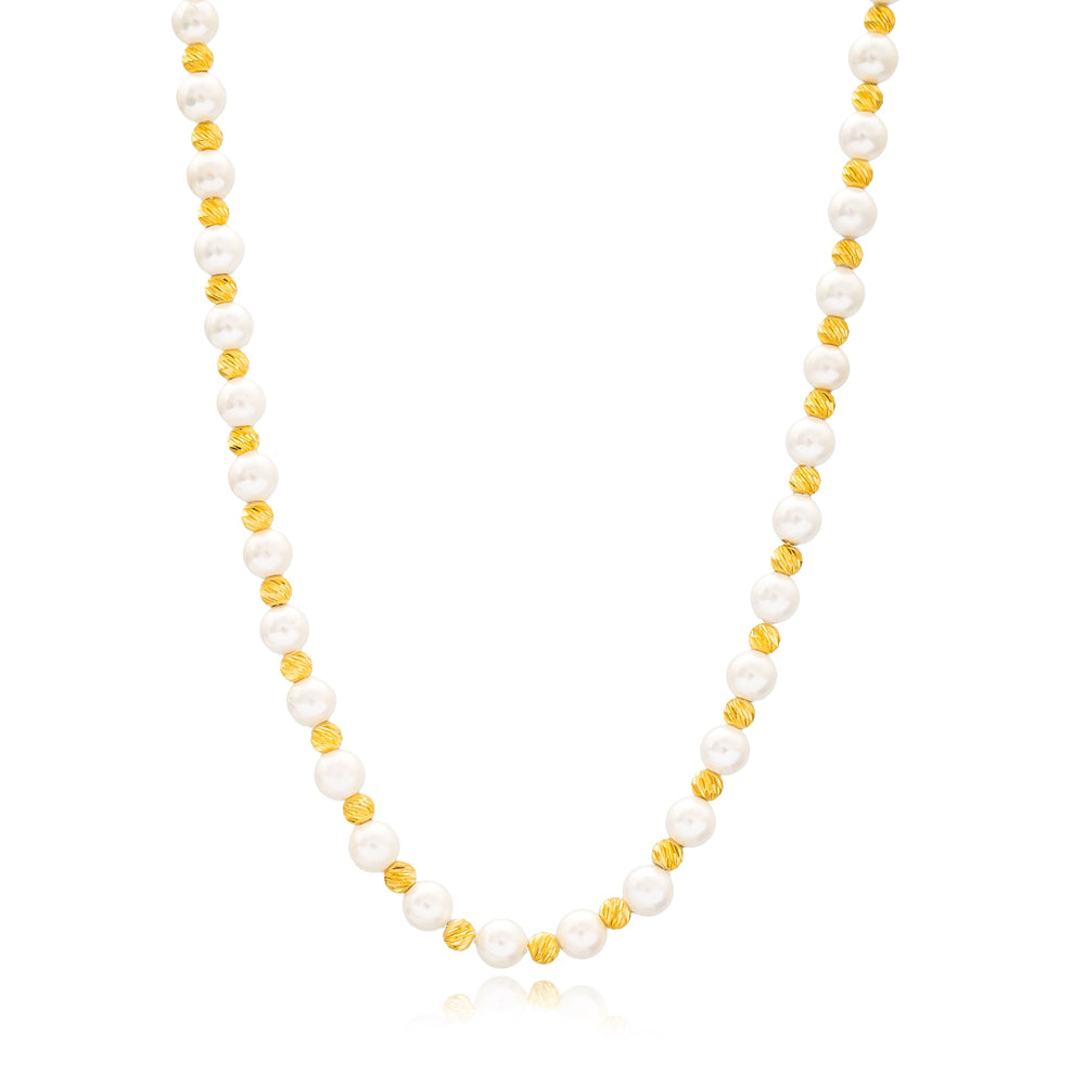 Elegant pearl stone necklace, delicate gold-toned chain with sparkling stones, stylish accessory for cocktail dinner or evening wear.